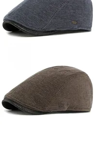 Close-up of corduroy texture and metallic buckle on retro ivy cap with leather trim