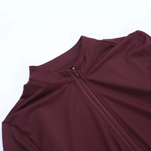 Close-up of wine red stand-up collar with half-zipper and fine stitching on yoga top