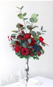 Floral centerpiece with red and navy roses in silver vase for wedding table decor