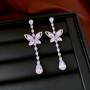 Silver needle butterfly drop earrings with zircon crystals on premium velvet display