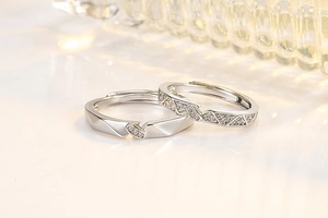 Macro view of silver zircon couple rings with geometric facets and micro-pave setting