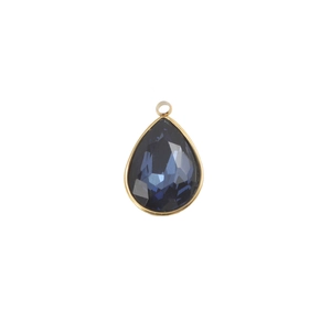 Detail of teardrop faceted blue birthstone pendant with gold plated stainless steel edge