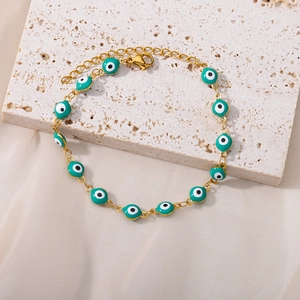 Detail of evil eye bracelet with turquoise enamel beads and adjustable gold chain