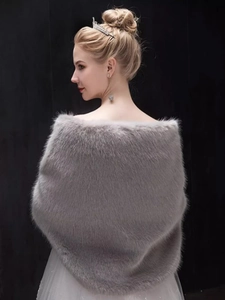 Detail view of a luxury grey faux fur bridal shawl worn by a model against a black backdrop