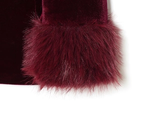 Close-up of velvet blazer sleeve featuring plush faux fur trim in burgundy red color