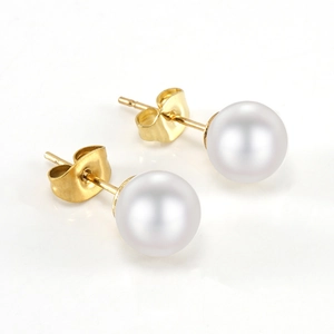 Minimalist pearl earrings with golden titanium steel posts on white reflective background