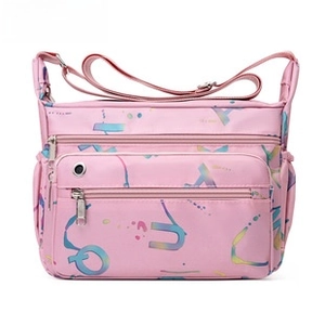 Close-up of pink crossbody bag featuring multi-zipper pockets and colorful letter prints