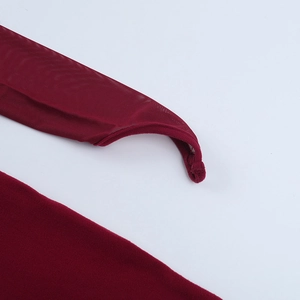 Detail of wine red mesh and solid fabric stitching with thumbhole sleeve design