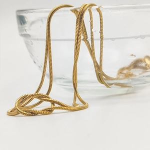 Detailed close-up of 14K gold plated stainless steel snake chain with waterproof finish