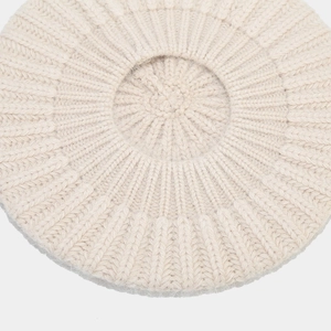 Top view of beige rabbit fur knit beret featuring warm ribbed texture and vintage style