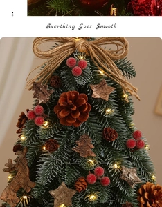 Detail of mini Christmas tree with LED lights, pine cones, berries, and wood ornaments
