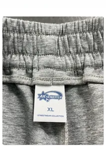 Detail of grey joggers featuring an elastic waistband with an XL size label and tag