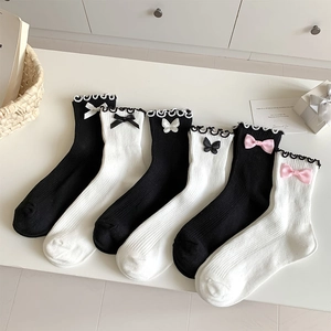 Detail of JK style mid-calf socks with delicate lace cuffs and cute bowknot accents