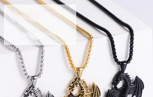 Detailed view of punk flying dragon pendants in gold, silver and black metal finishes