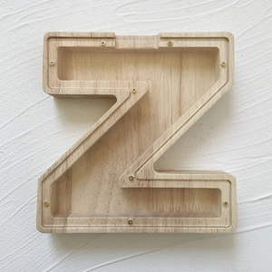 Macro view of Z-shaped oak wood money box with transparent acrylic cover and gold screws