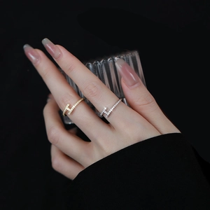 Close-up of gold and silver plated H-shaped rings with pavé cubic zirconia accents