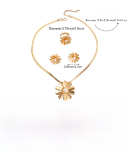 Detailed view of golden daisy jewelry set with pearl centers and snake chain necklace
