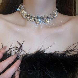 Macro shot of silver rhinestone necklace featuring teardrop and square crystal details