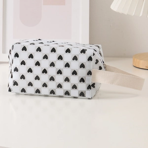Detailed side view of translucent checkerboard pencil case with heart pattern and strap
