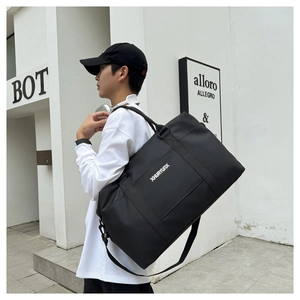 Detail of a large black Oxford travel bag featuring adjustable shoulder strap and metal hooks