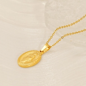 Detail of gold-plated Virgin Mary pendant on silk with religious relief and steel chain