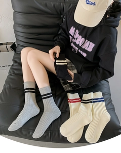Detailed close-up of ribbed combed cotton crew socks with double stripes in multi-colors