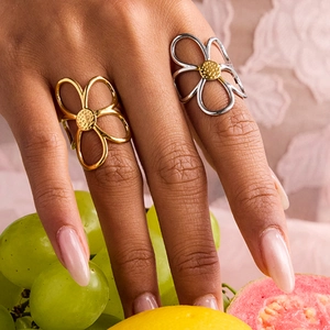 Detailed shot of hollow flower rings in gold and silver finish with polished metal petals