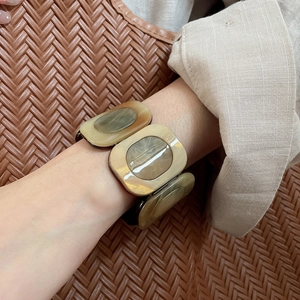 Detail view of resin stretch bracelet with earth-toned marbled rectangular links