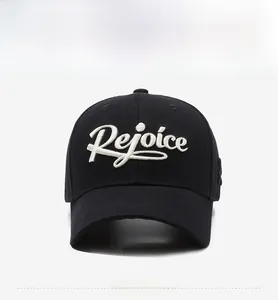 Detail of black cotton baseball cap with white 3D Rejoice embroidery and curved brim