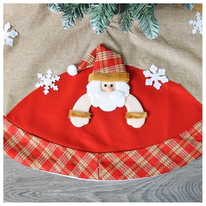 Detail of Christmas tree skirt with Santa Claus applique and red plaid border decor