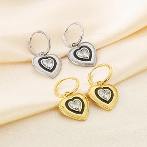 Detail of 18K gold and silver heart hoop earrings with black enamel and crystals