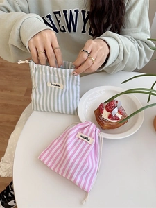 Vertical striped drawstring storage pouches in soft pink and light green fabric
