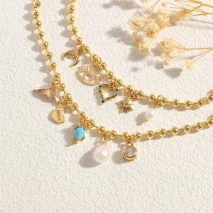 Exotic golden beaded necklace featuring baroque pearl and colorful zircon charms