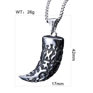 Macro view of vintage wolf tooth pendant with ethnic carvings and size measurements