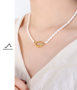 Detail of freshwater baroque pearl necklace with a gold-plated stainless steel ring element