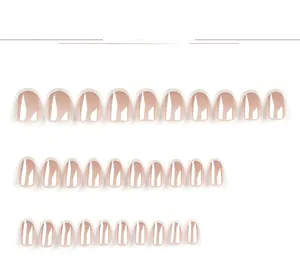 Detailed view of nude French manicure press-on nails with white tips in various sizes
