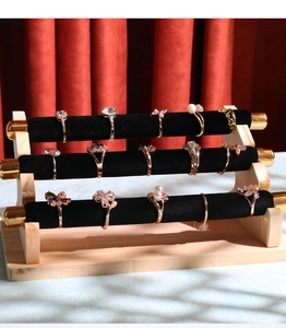 Three-tier velvet ring display stand with solid wood base and gold metal end caps
