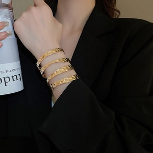 Detailed macro view of the gold multi-layer hammered metal bangle with textured finish