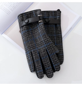Detail of wool tweed plaid gloves featuring leather wrist strap and metallic buckle