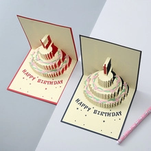 Macro detail of a 3D pop-up birthday card showing a three-layer paper cake design