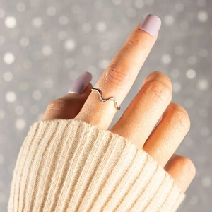 S925 sterling silver wave ring with zircons shown on hand with elegant knit sweater