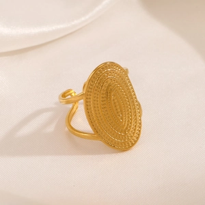 Adjustable 18K gold plated oval geometric ring with hammered texture on silk fabric