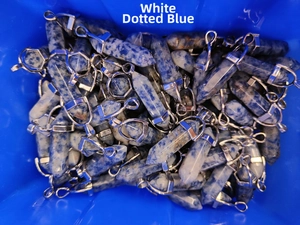 Macro view of blue sodalite hexagonal bullet stone pendants with silver metal clasps