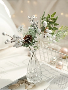 Close-up of white berries and pine cones in a glass vase for Christmas decor