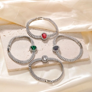 Elegant rhinestone square bracelets in red, green, and blue on silk fabric