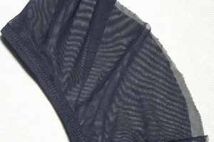 Close-up of the delicate black mesh fabric texture on this slim fit bodycon dress