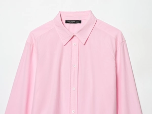 Close-up of pink cotton poplin shirt neckline with Zeal Woman brand label and button detail