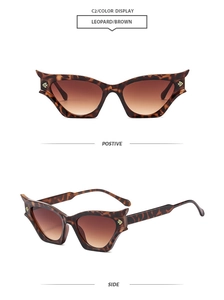 Detail view of leopard print cat eye sunglasses with brown gradient lenses and gold accents