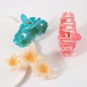 Detailopname van doorschijnende bloem haarklemmen in blauw, roze en wit met metalen veer