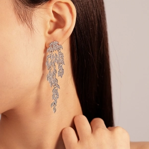 Elegant silver leaf tassel earrings with rhinestones on model for a luxury look